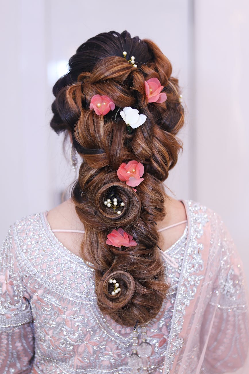 woman wearing pink and white floral top with red and white floral hair dress