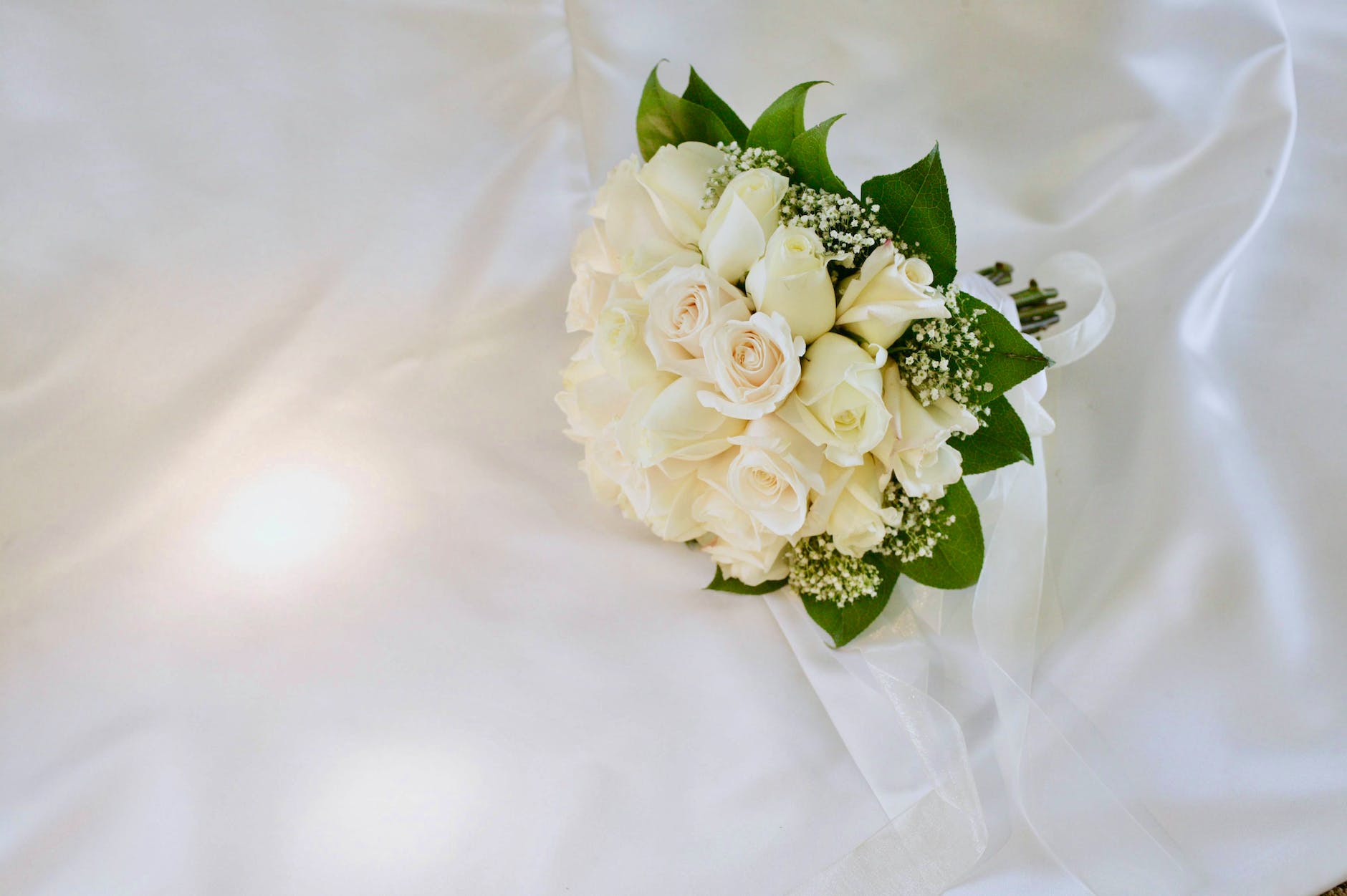 bouquet of white petaled flowers on white surface