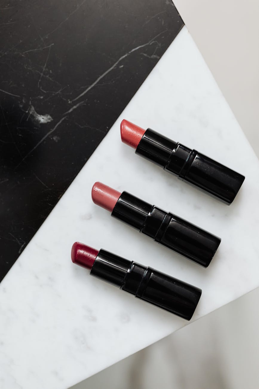 three lipsticks on white background