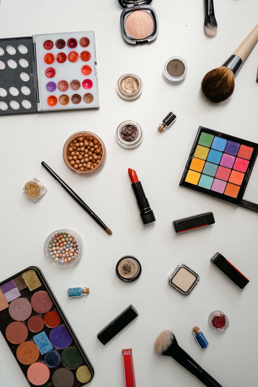 an assortment of beauty products on a white surface