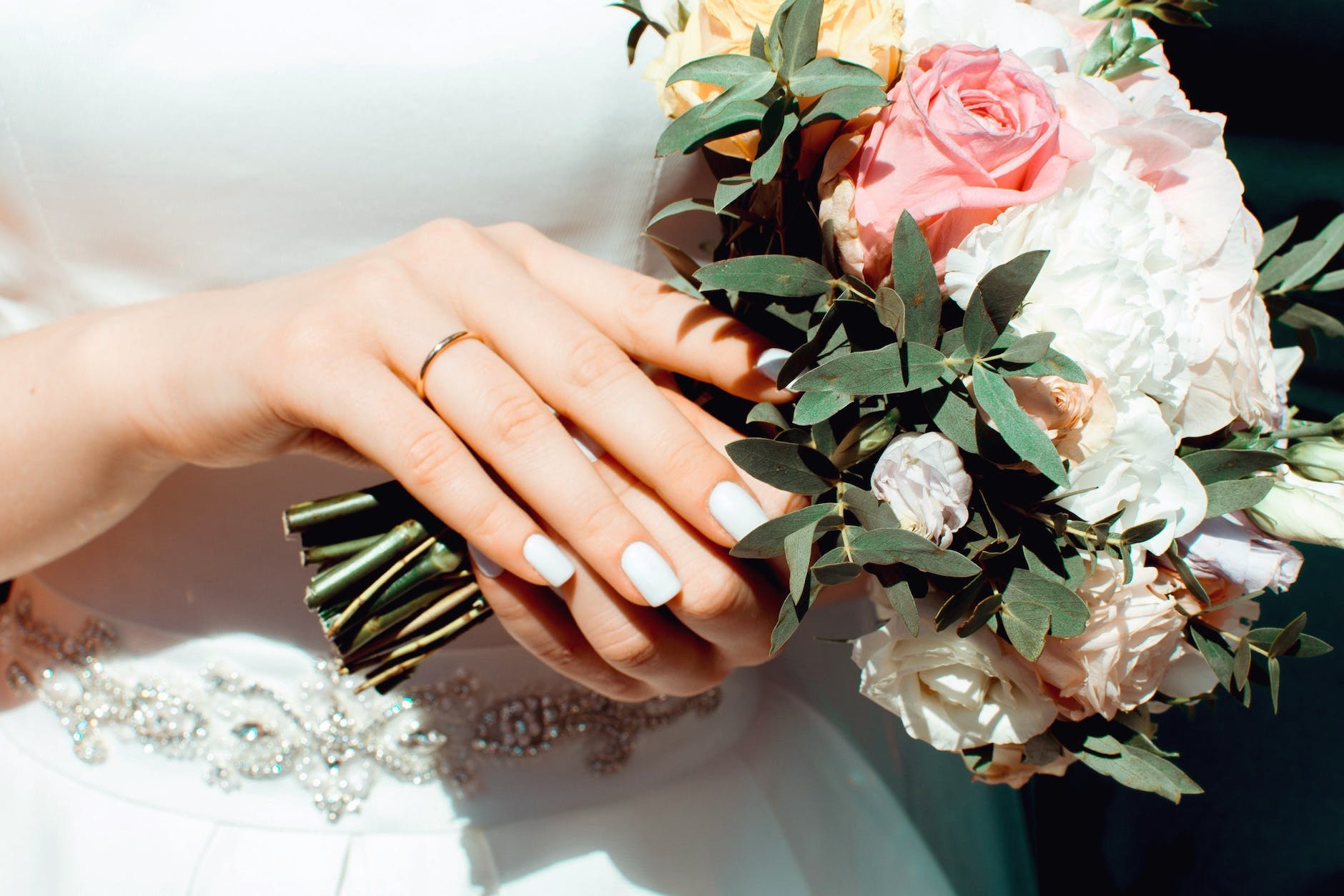 woman holding white and pink roses bouquet