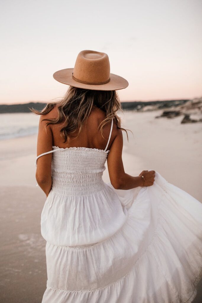 woman in white dress and wide brim hat