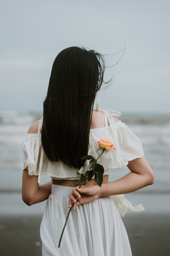 photo of woman holding a flower